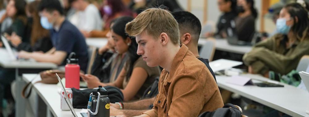 student sitting at desk, first day of classes